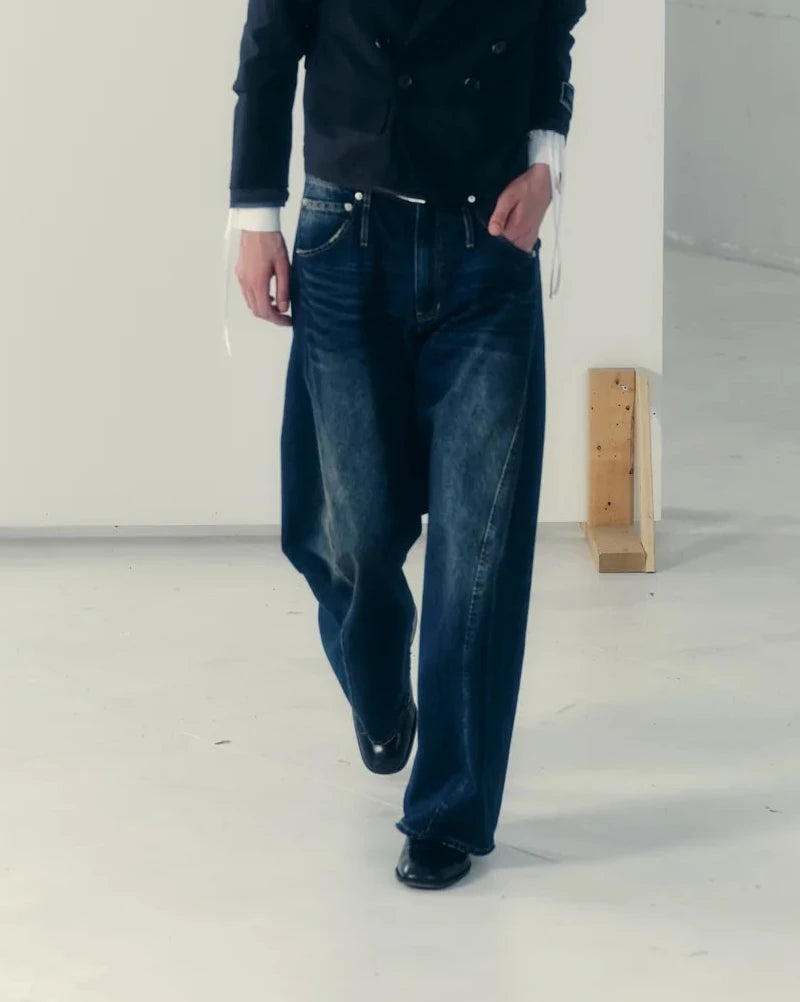 aging twisted denim pants