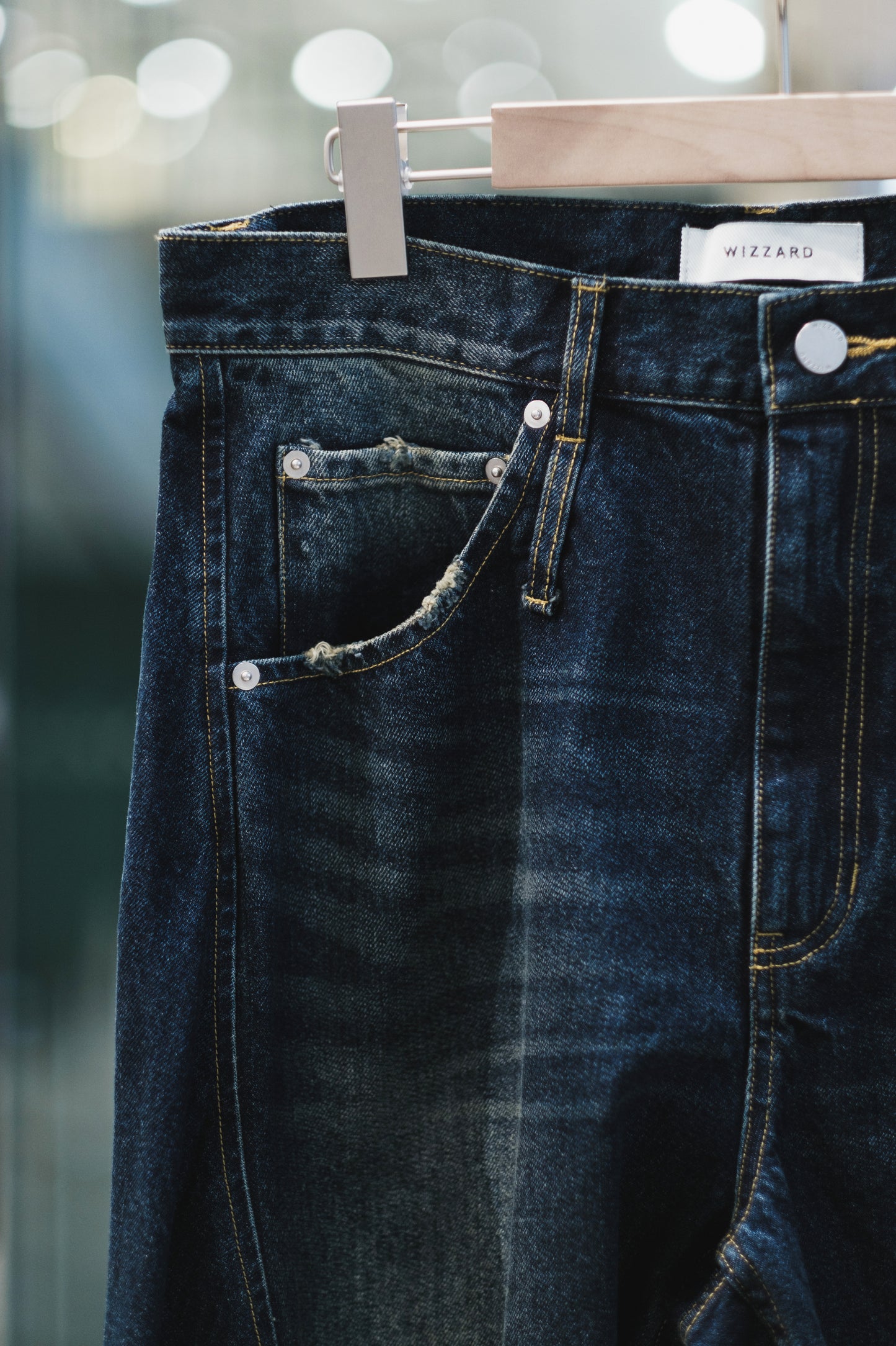 aging twisted denim pants
