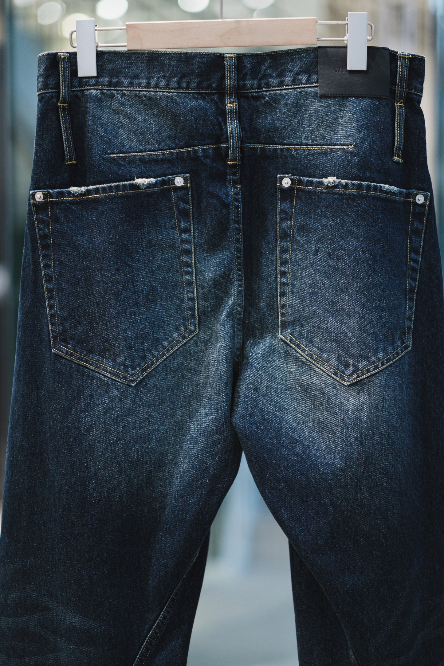 aging twisted denim pants