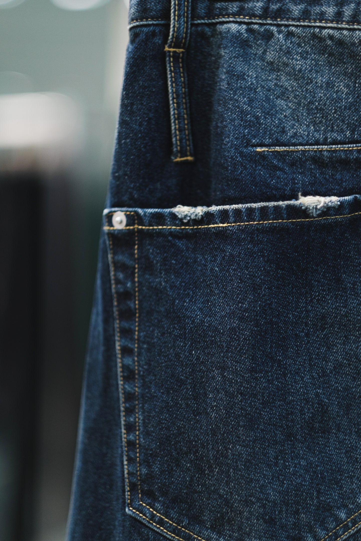 aging twisted denim pants