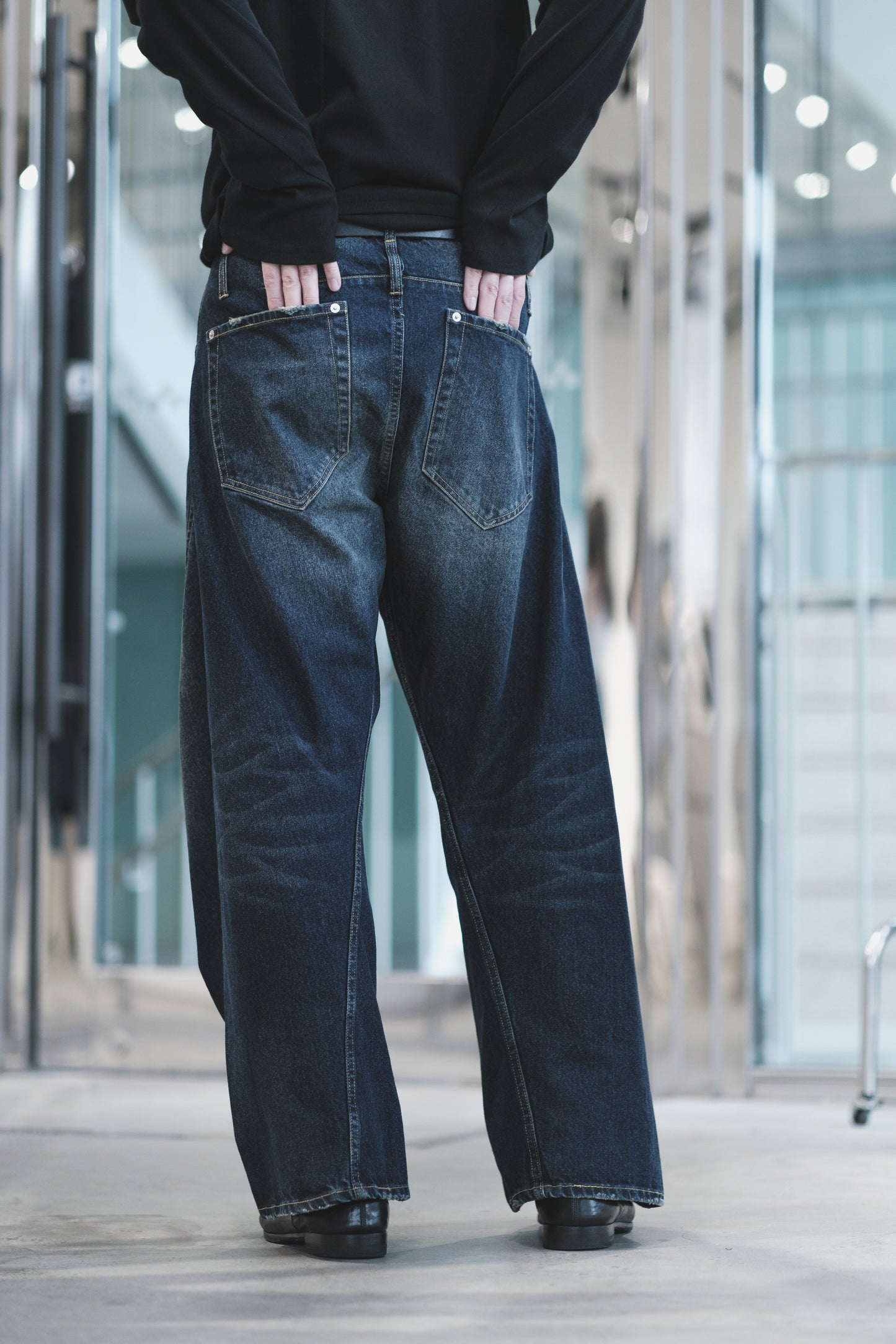 aging twisted denim pants