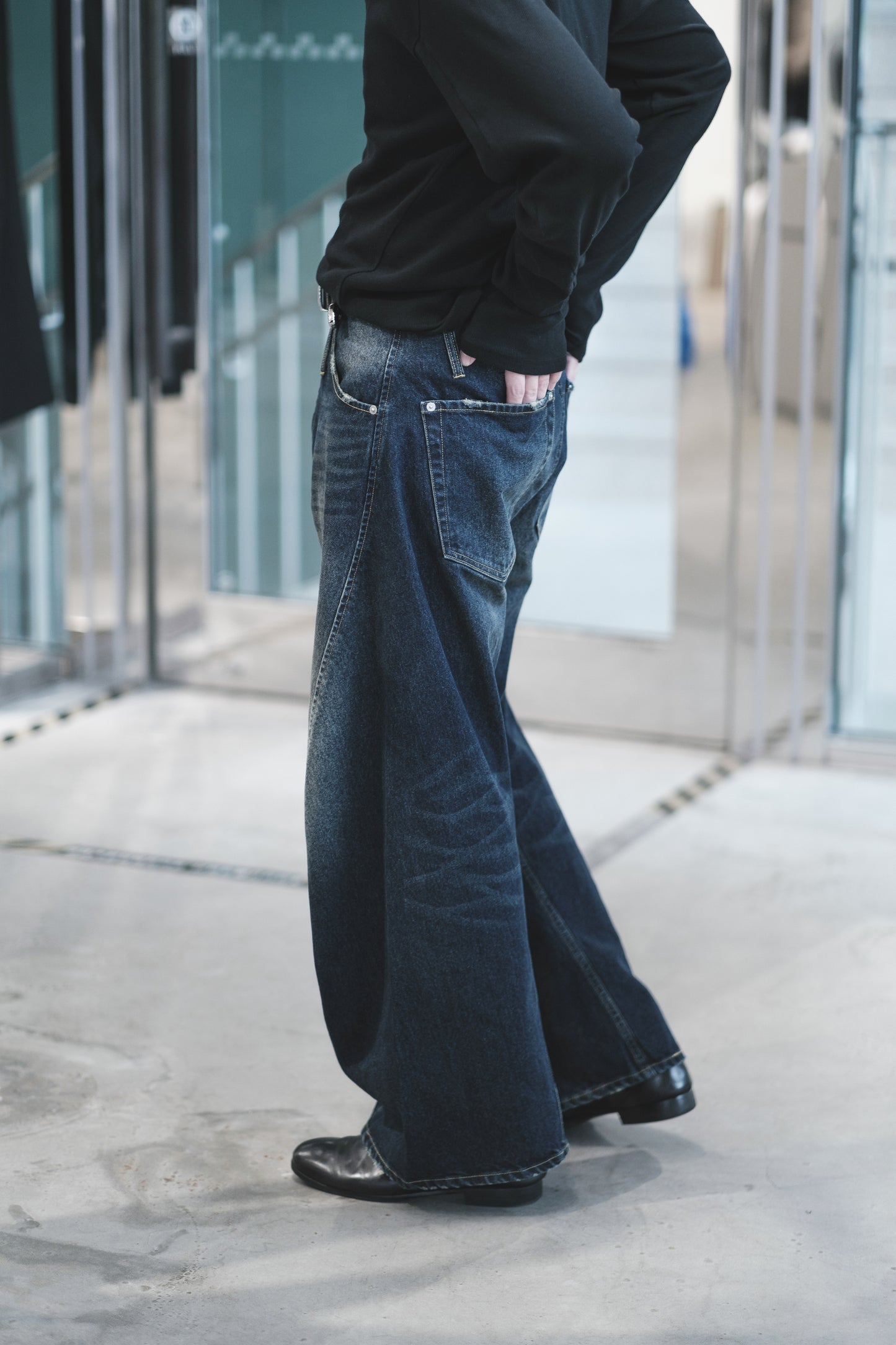 aging twisted denim pants