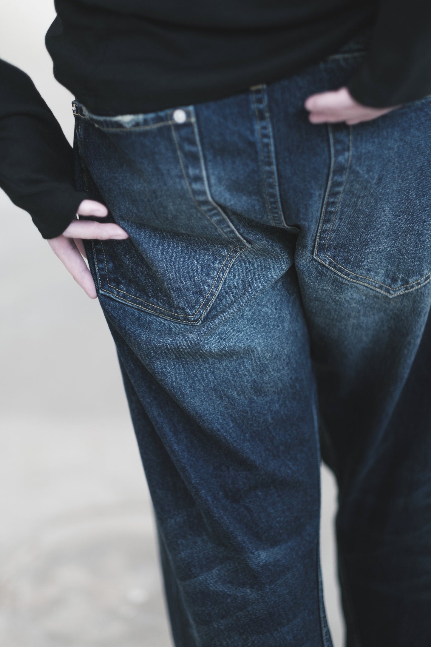 aging twisted denim pants