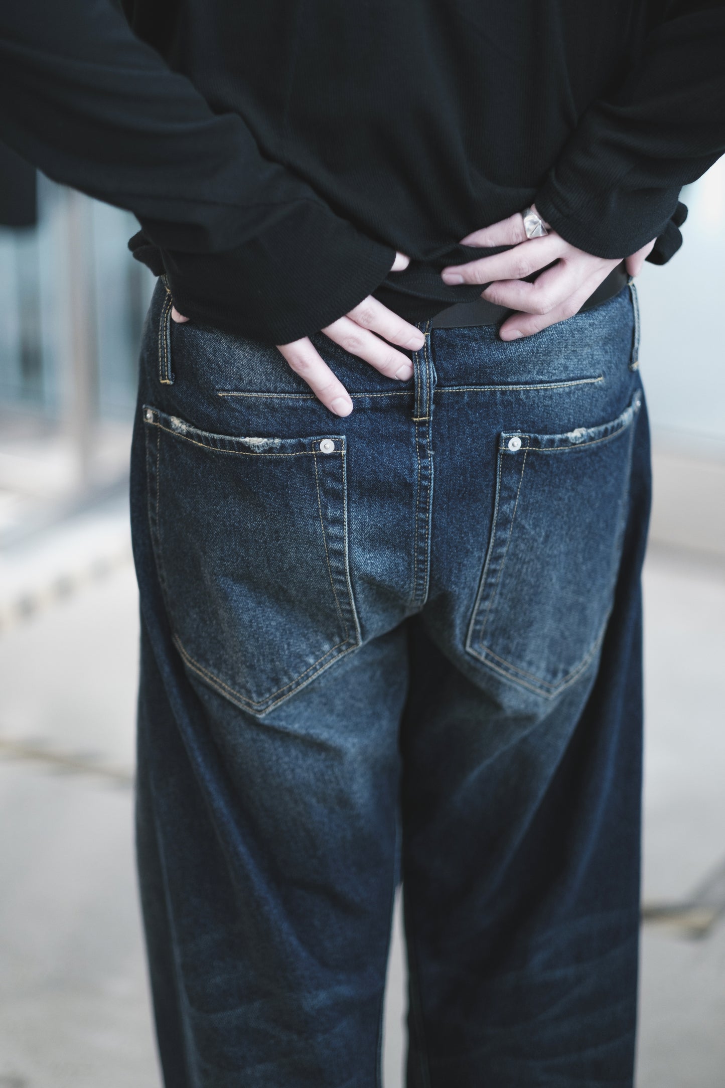 aging twisted denim pants