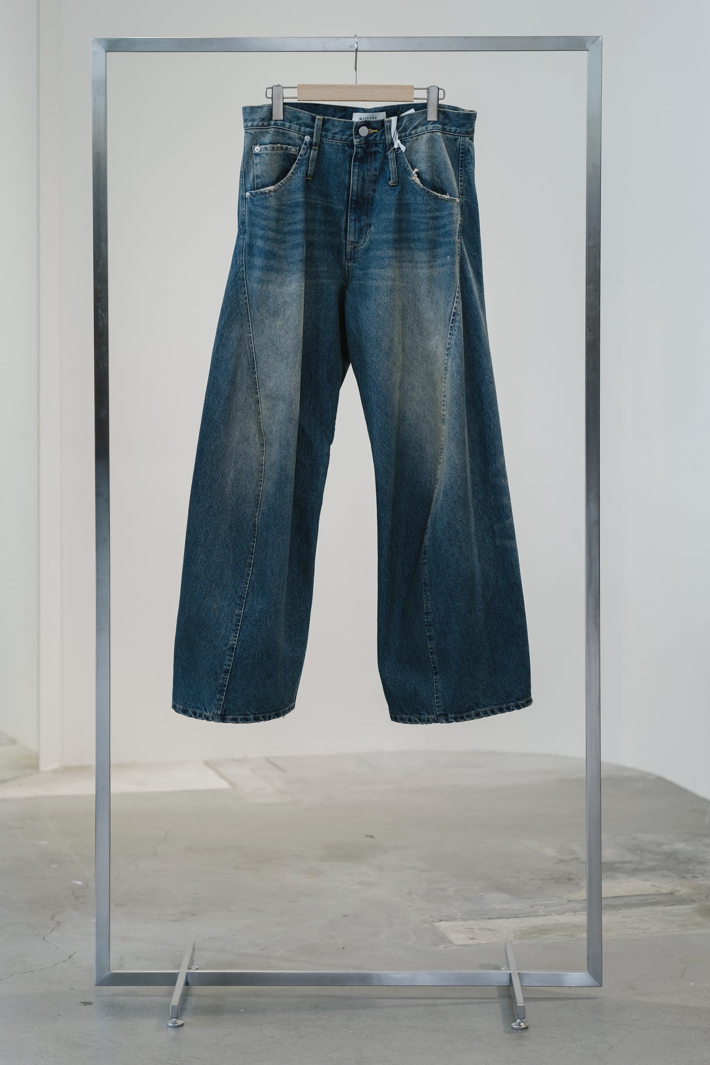 aging twisted denim pants