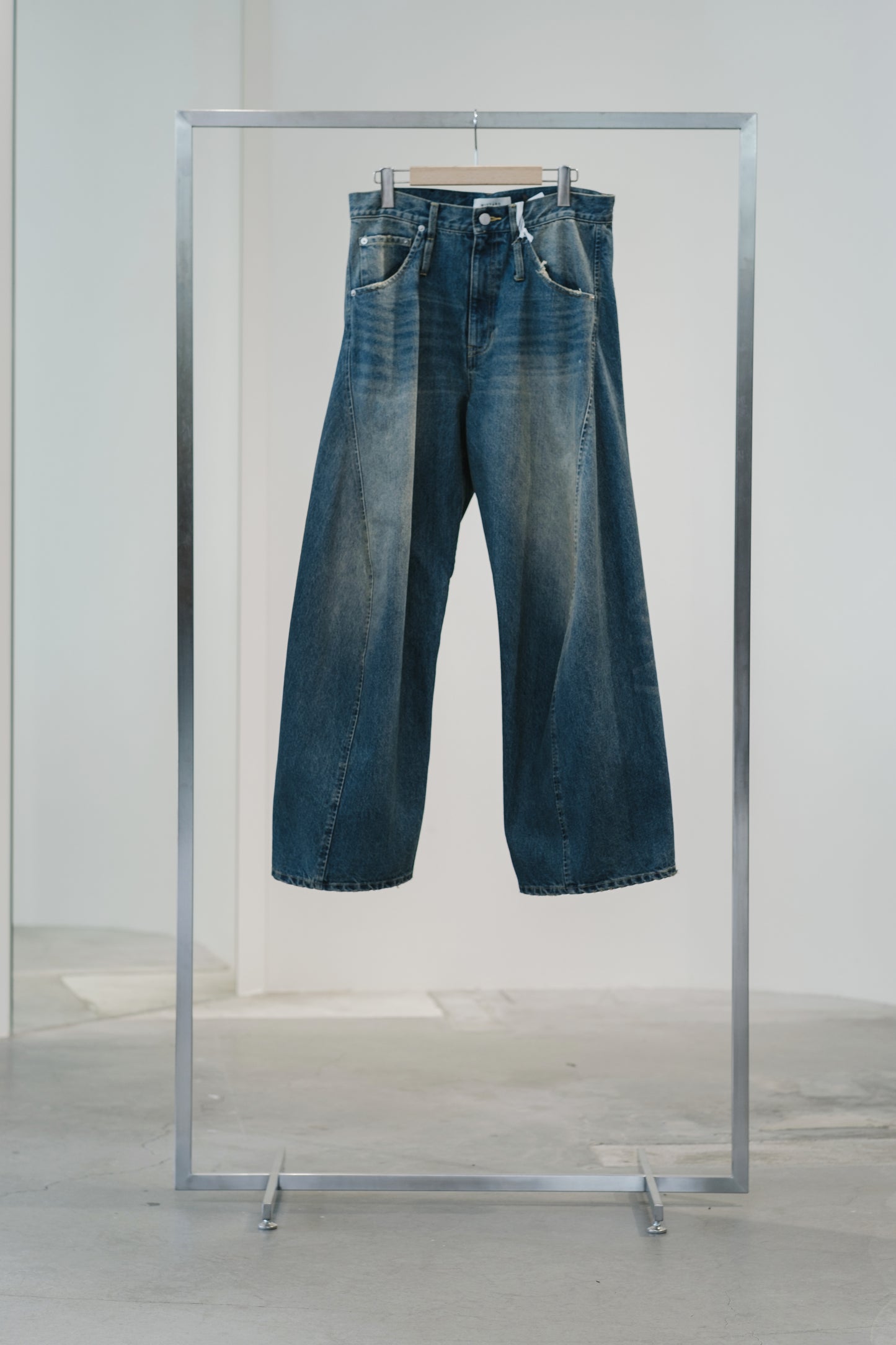 aging twisted denim pants