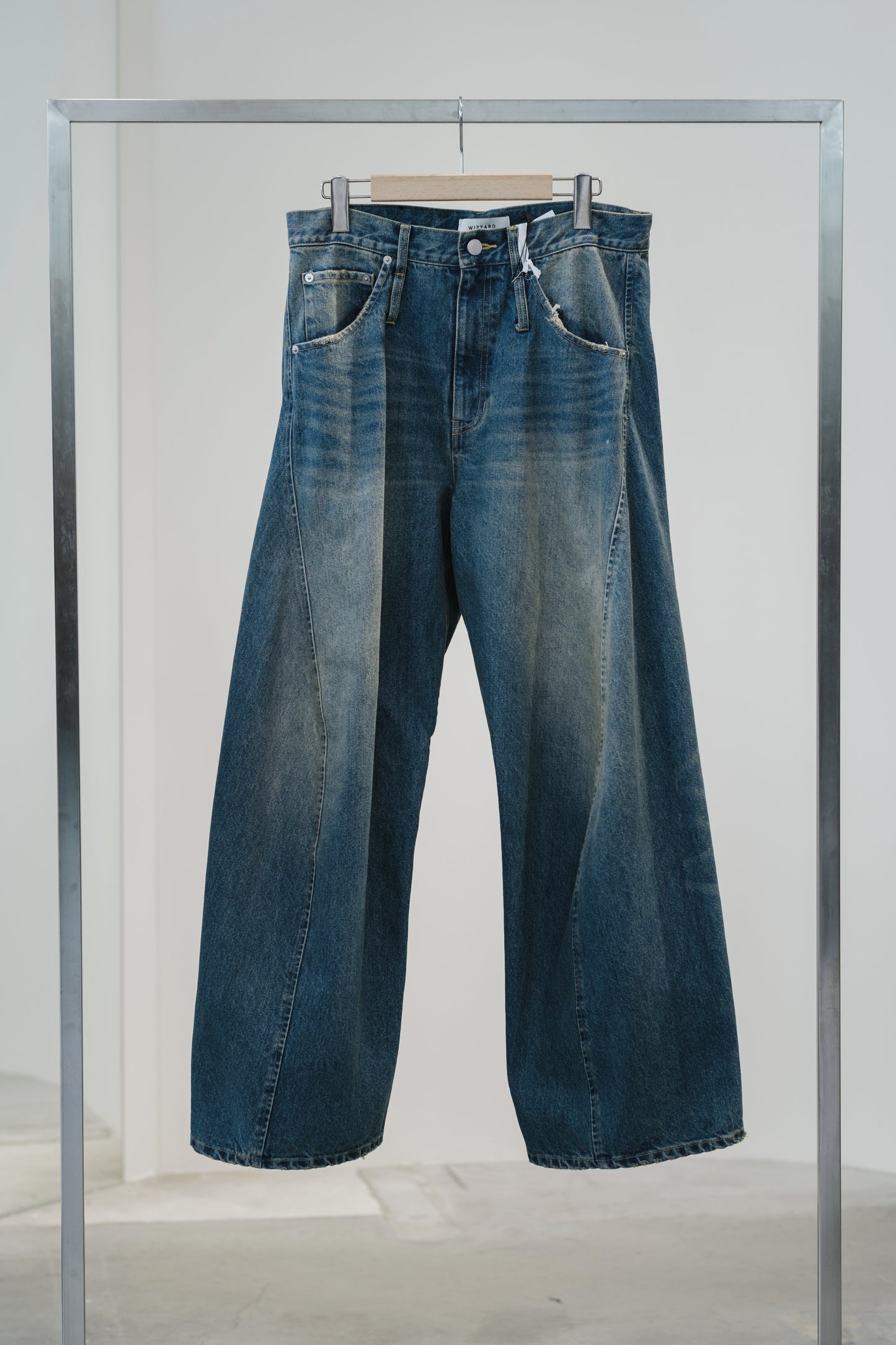 aging twisted denim pants