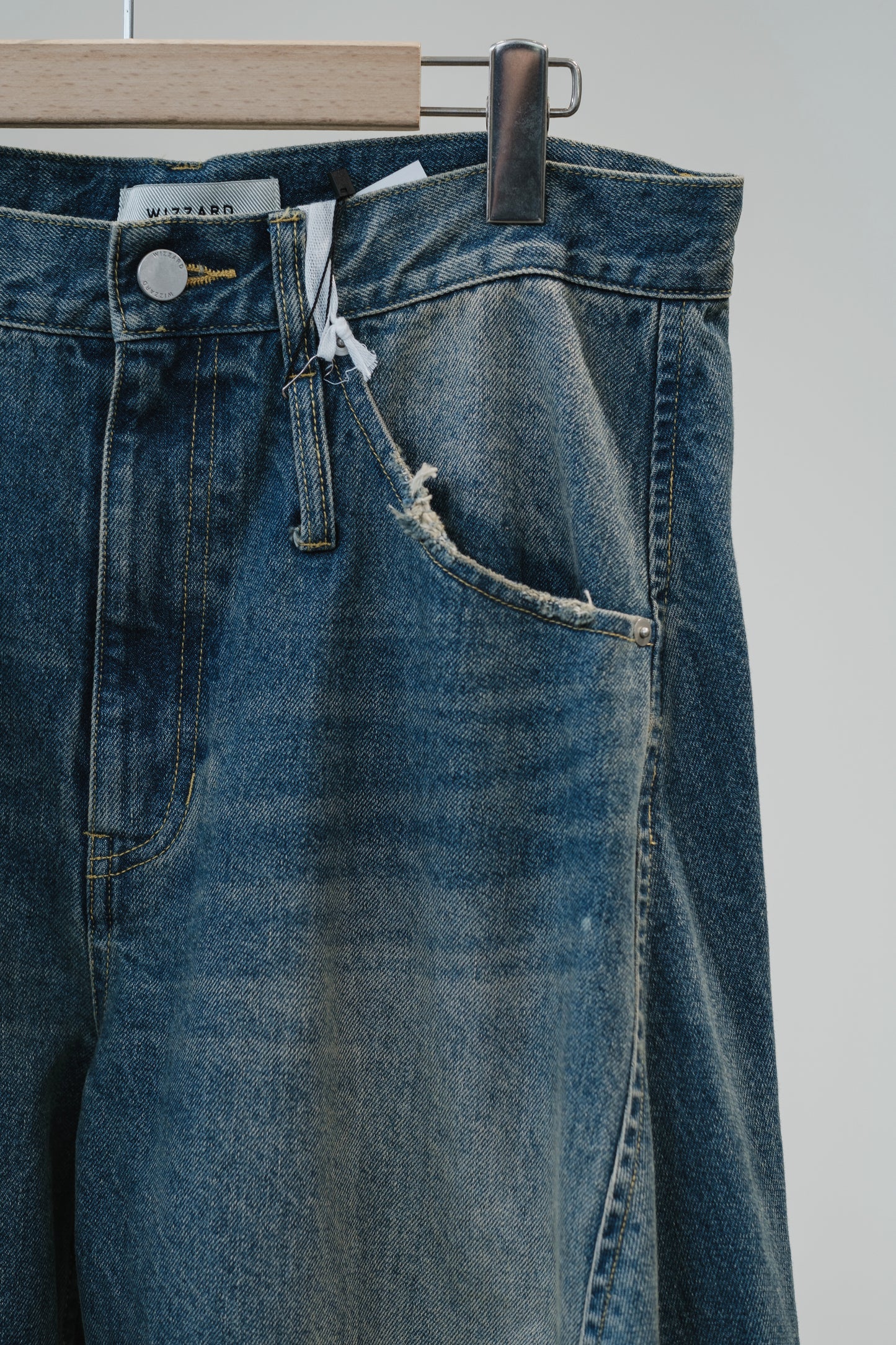 aging twisted denim pants