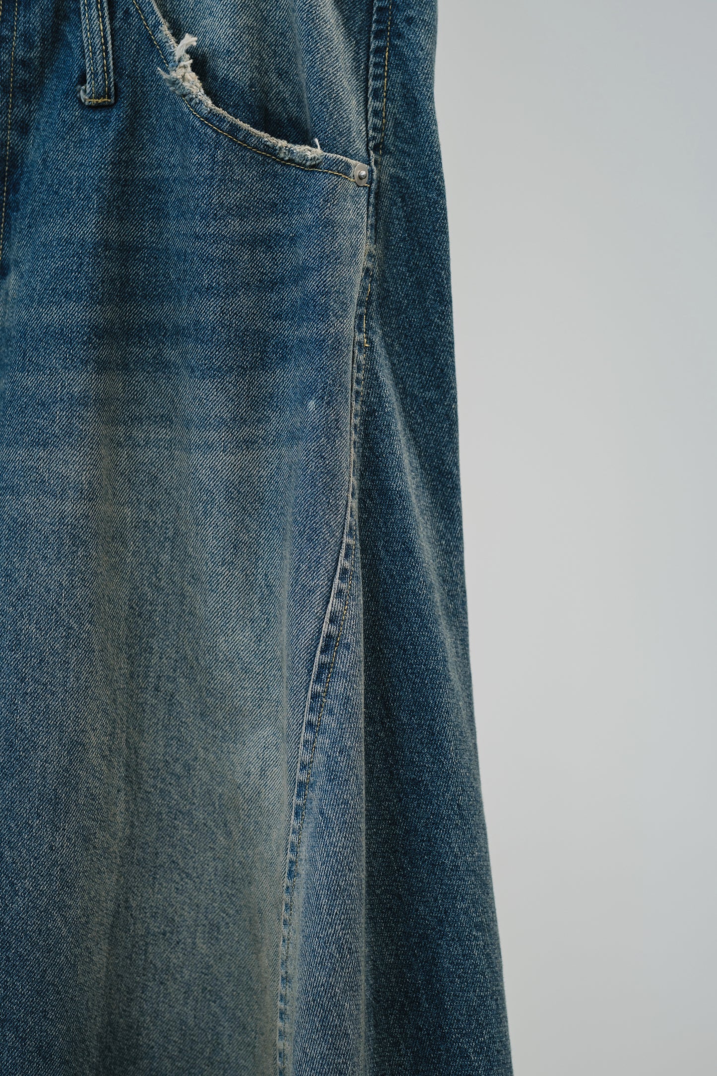 aging twisted denim pants