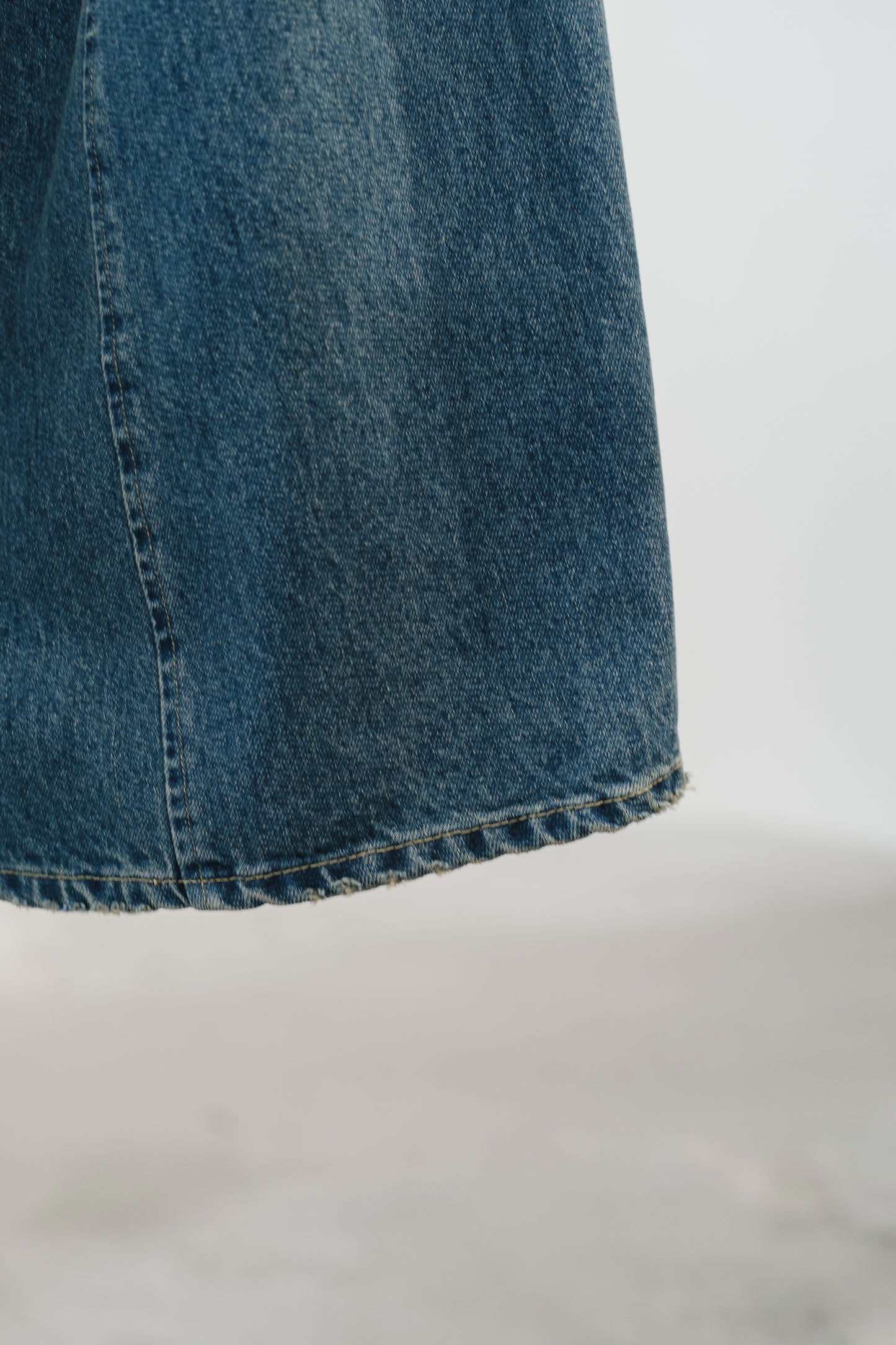 aging twisted denim pants