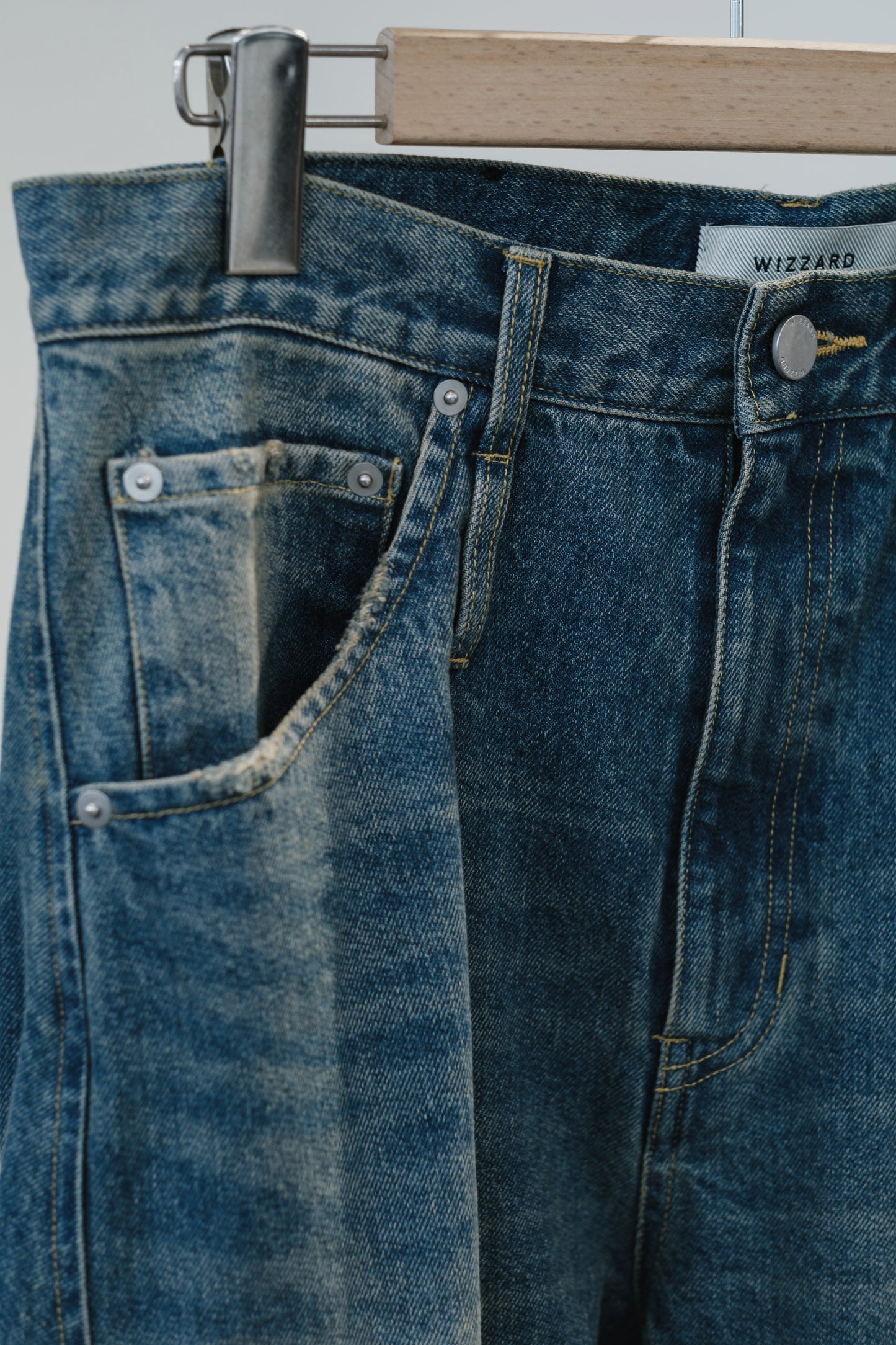 aging twisted denim pants