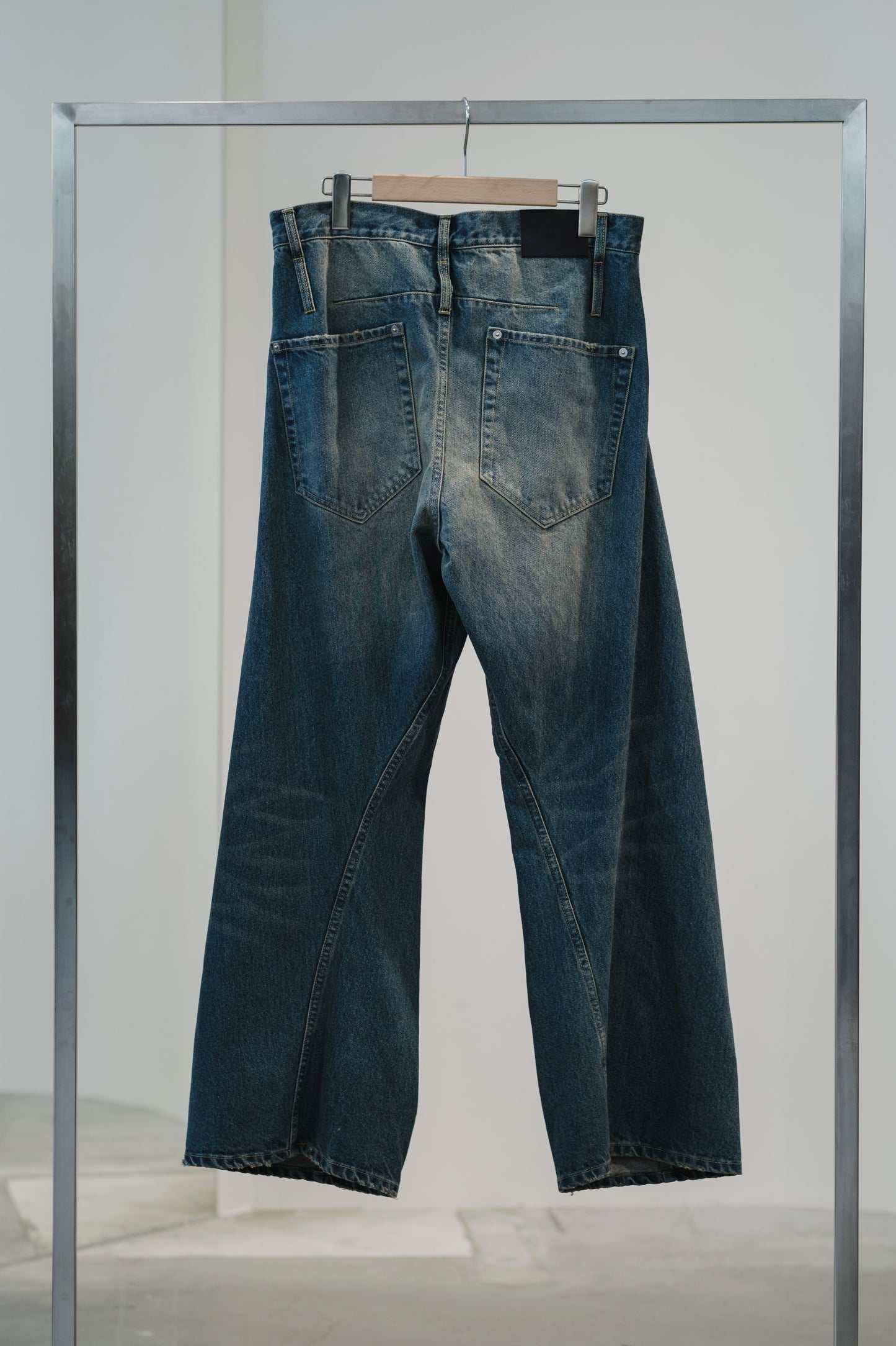 aging twisted denim pants