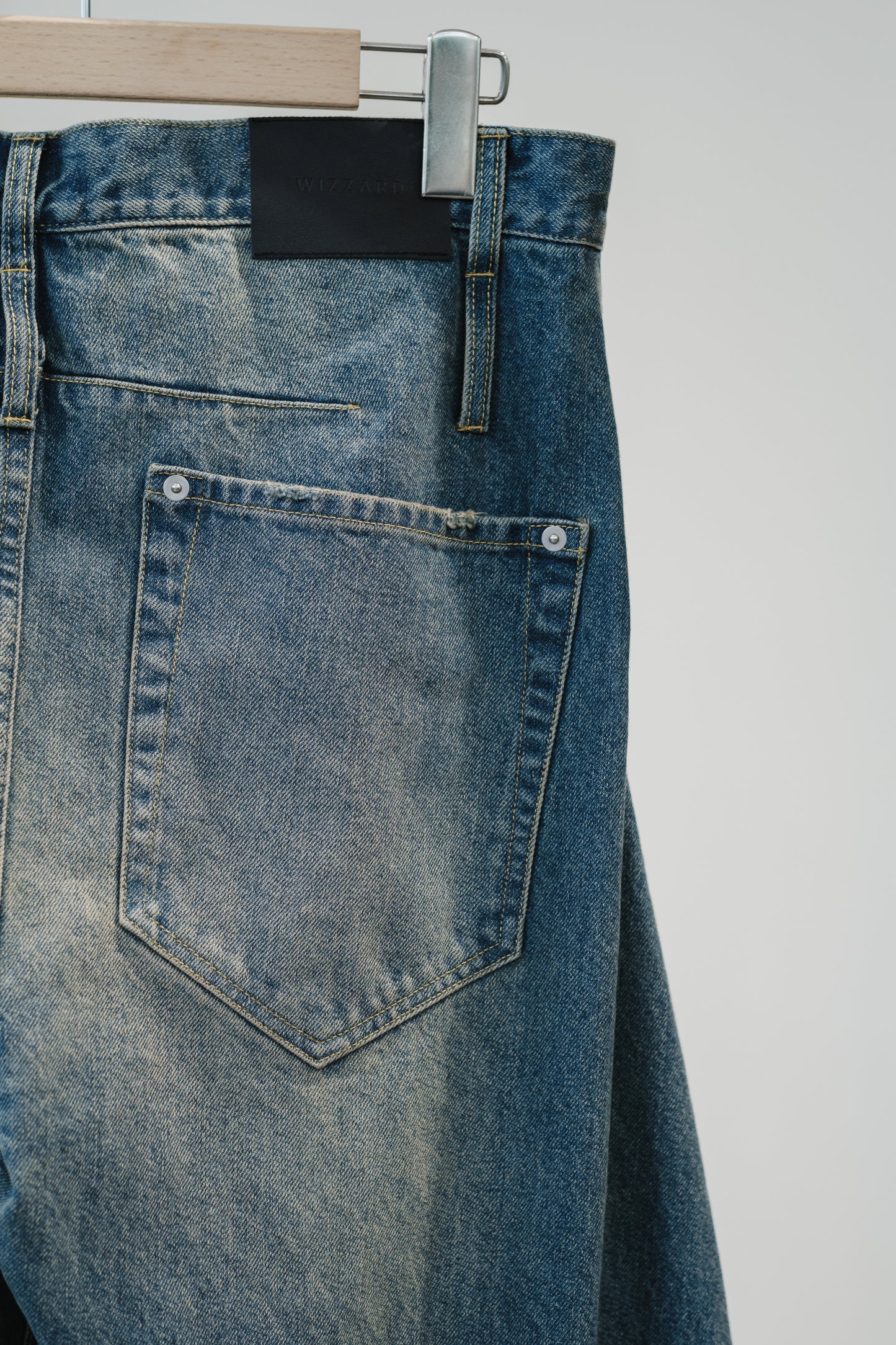 aging twisted denim pants