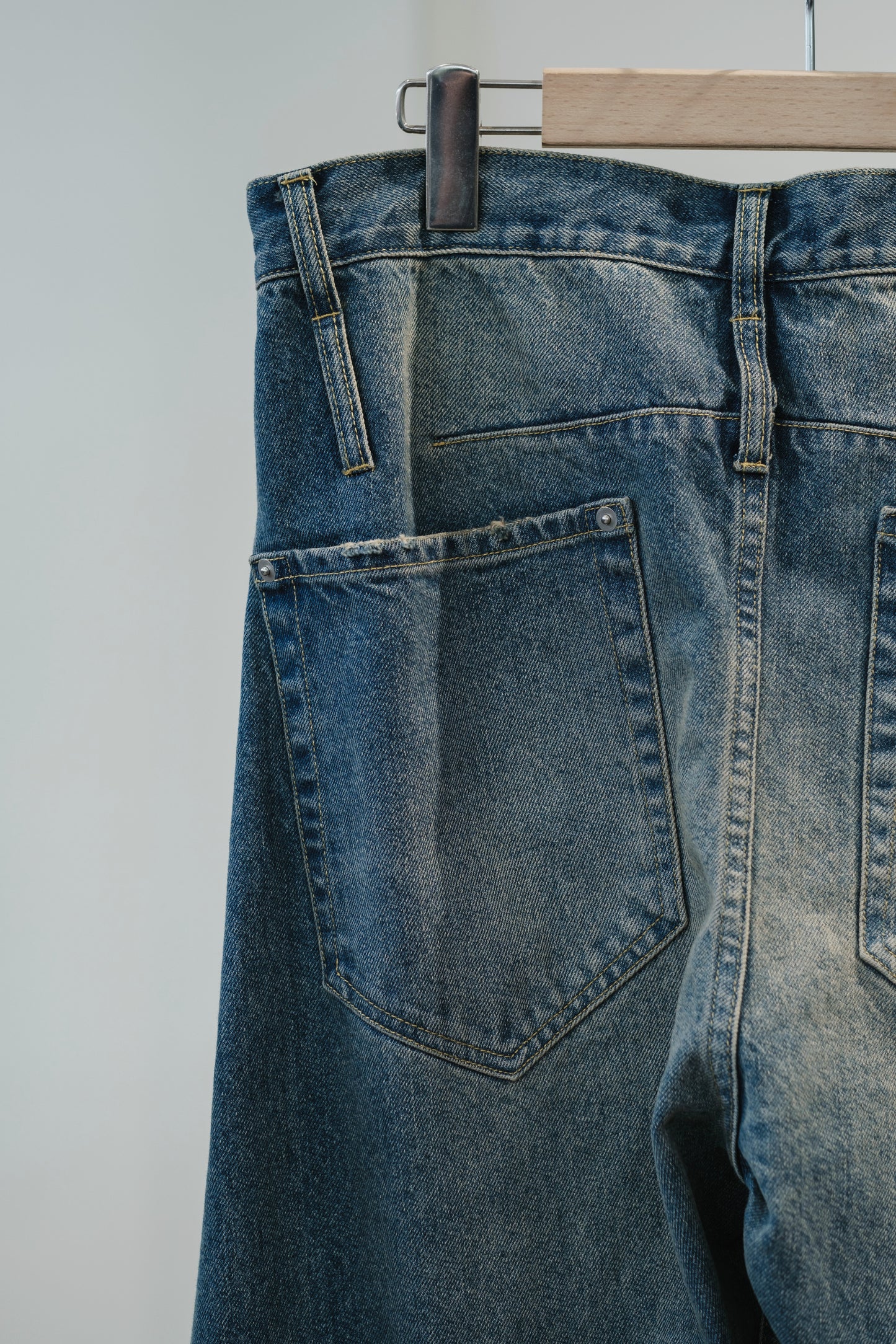 aging twisted denim pants