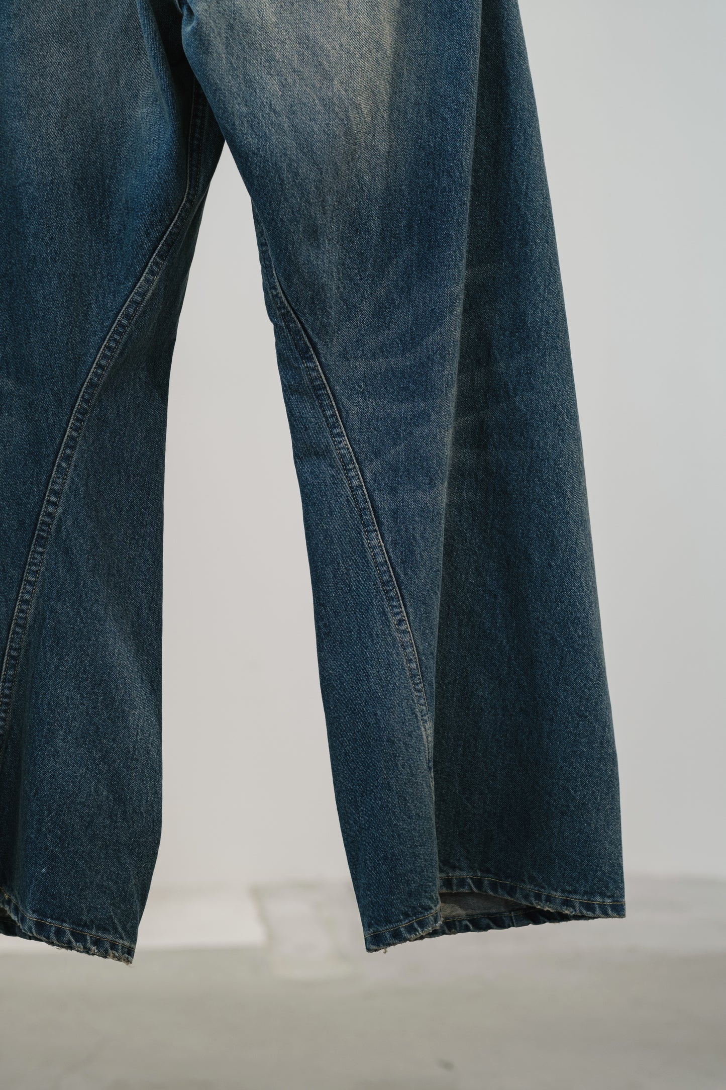 aging twisted denim pants