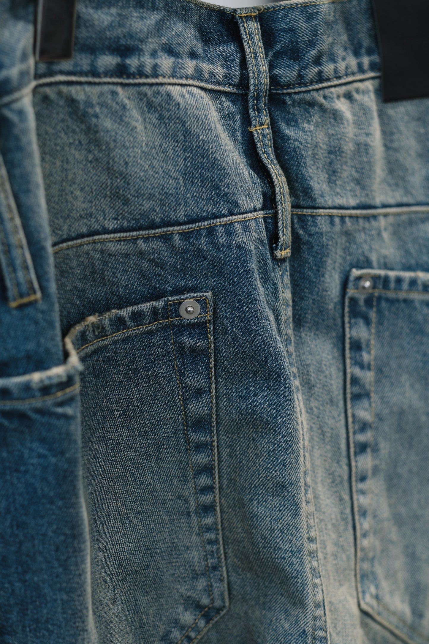 aging twisted denim pants