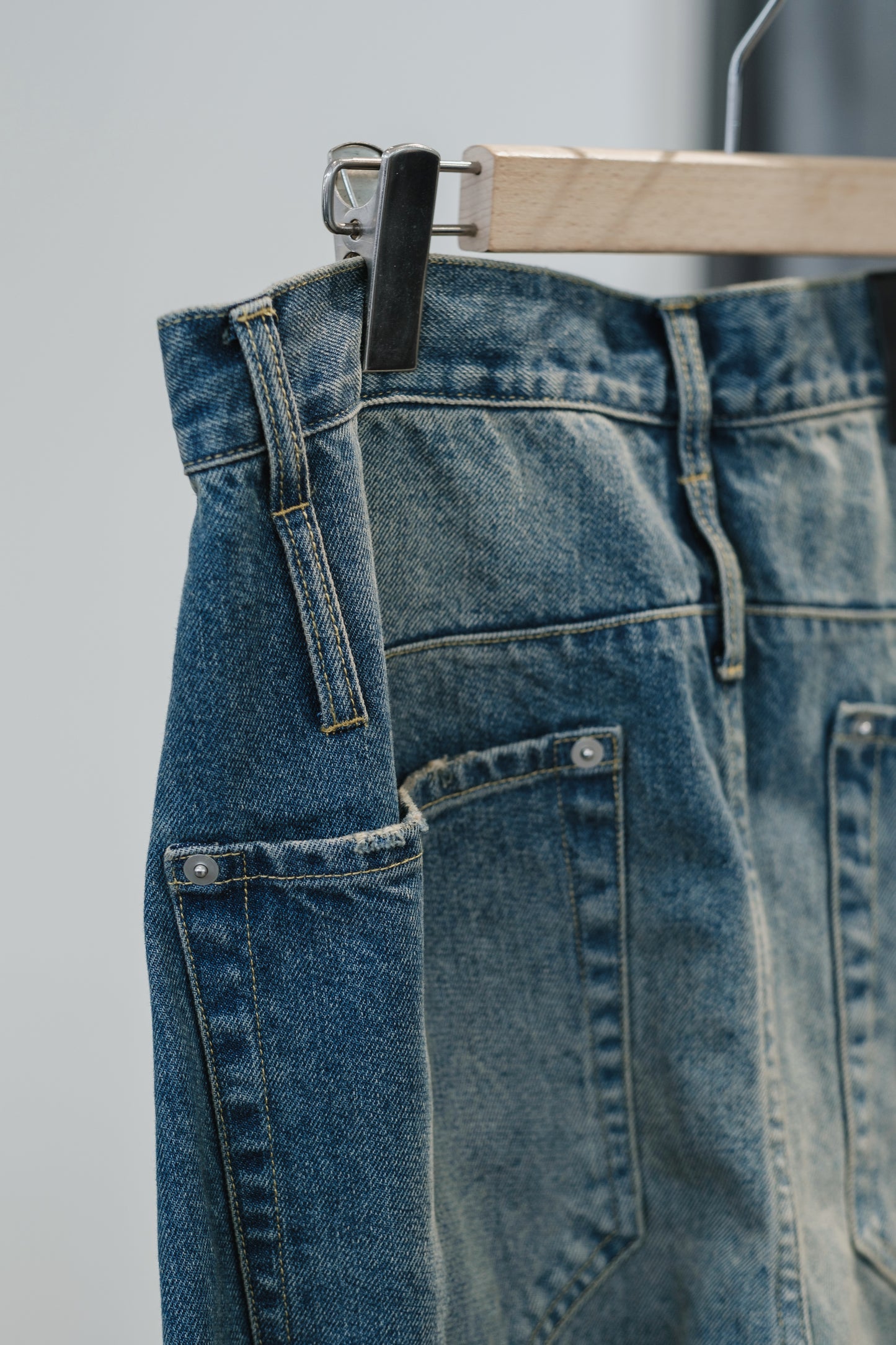 aging twisted denim pants