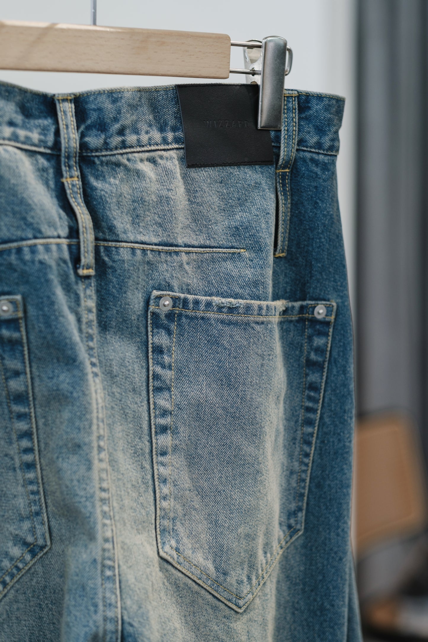 aging twisted denim pants